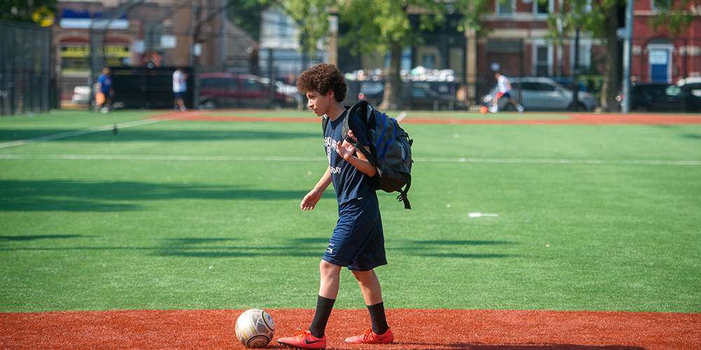 Young man playing soccer in Chicago.