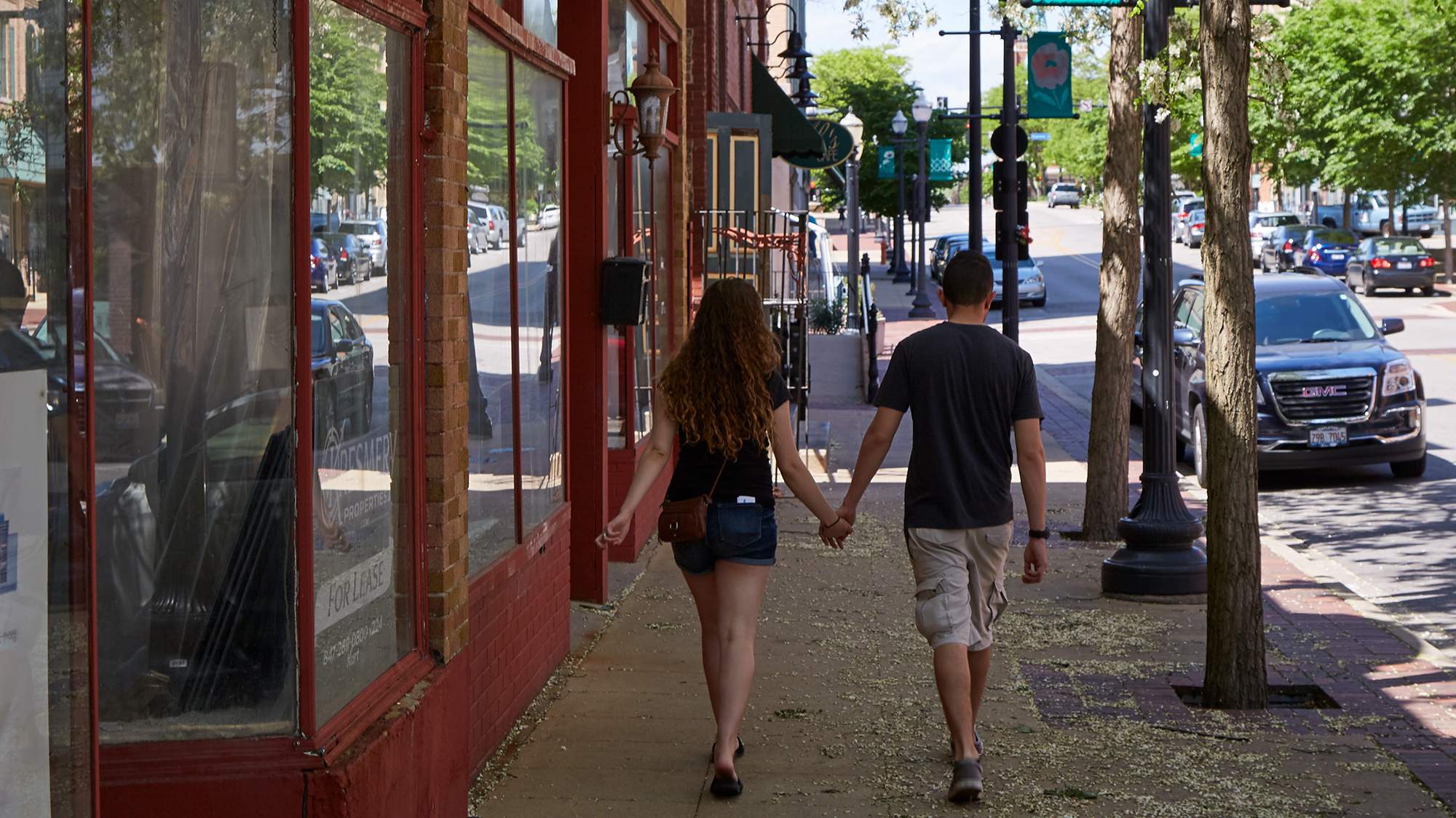 Two people walking in a suburban downtown in Kane County